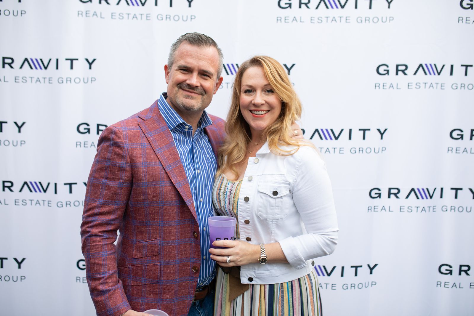 Gravity Real Estate Group founders in front of a Gravity backdrop