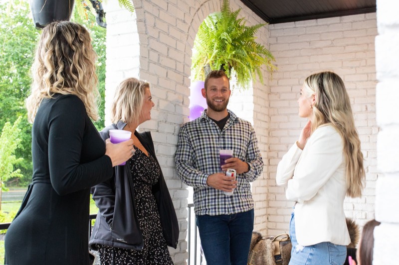 Gravity agents talking on a patio at a company event